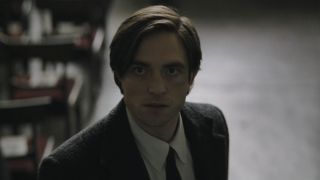 Bruce Wayne staring up during funeral in The Batman