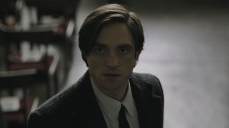 Bruce Wayne staring up during funeral in The Batman