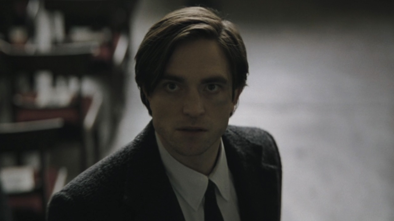 Bruce Wayne staring up during funeral in The Batman