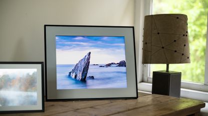 Aura Walden digital photo frame on a wooden sideboard