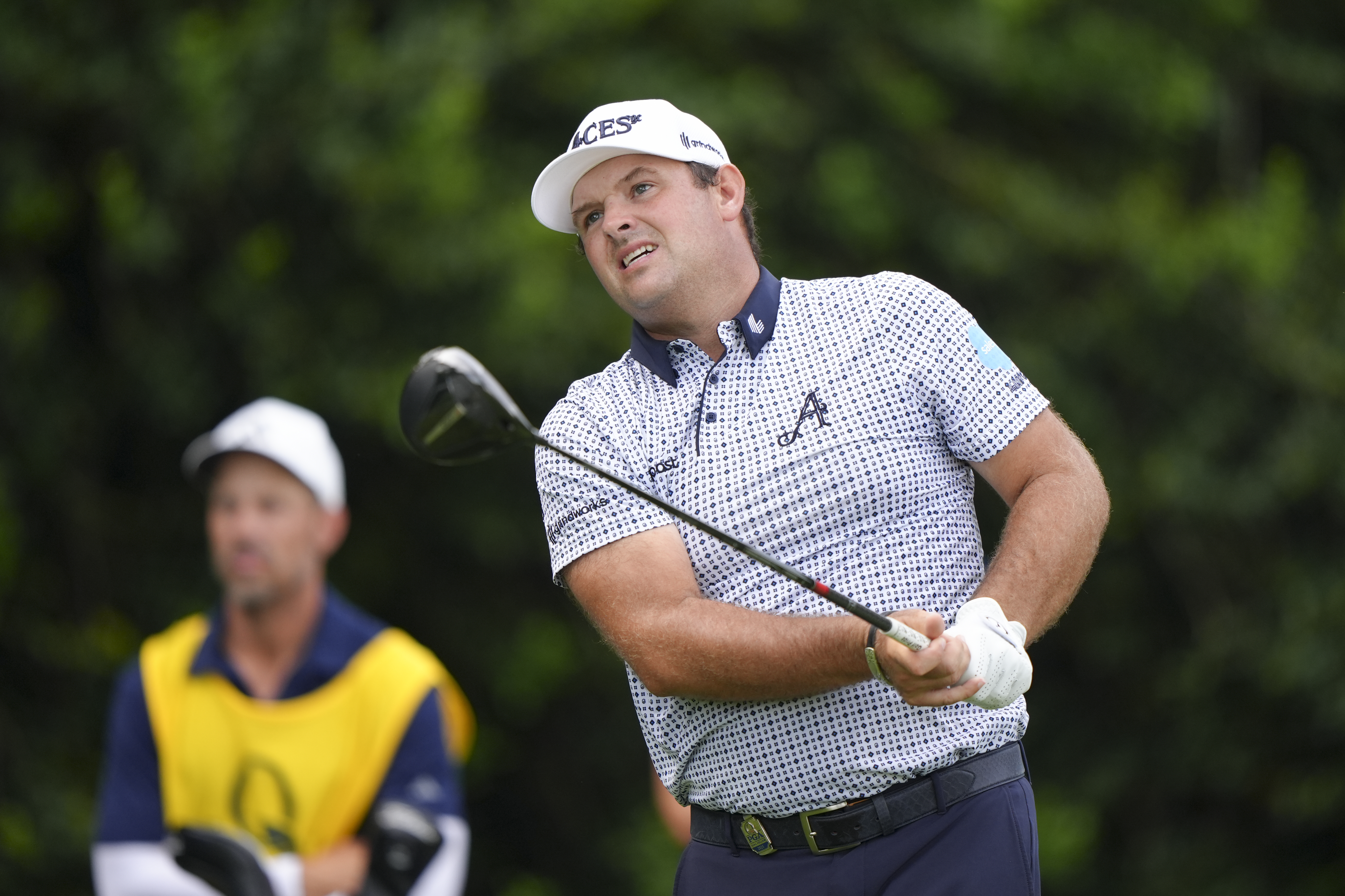 Patrick Reed hits a driver and watches it flight