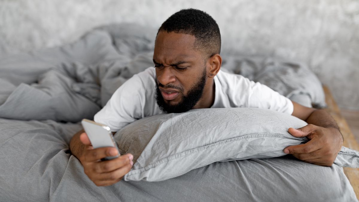 Man looking angrily at smartphone