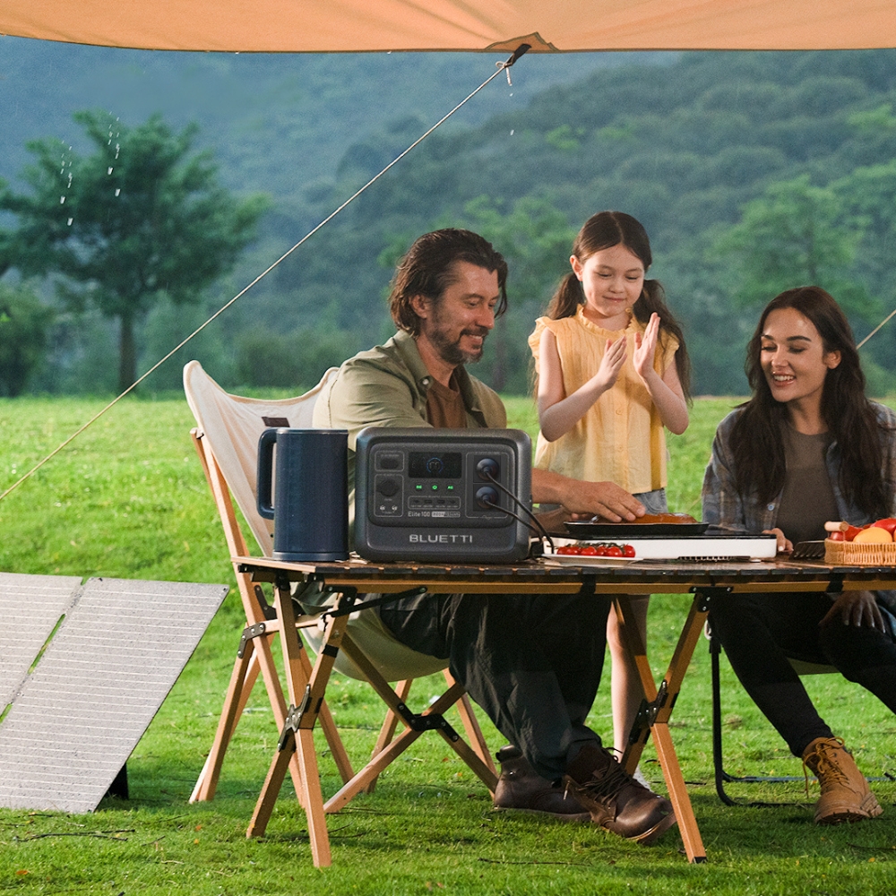 Family sitting outside with a Portable Power Station on the table sold at Bluetti 