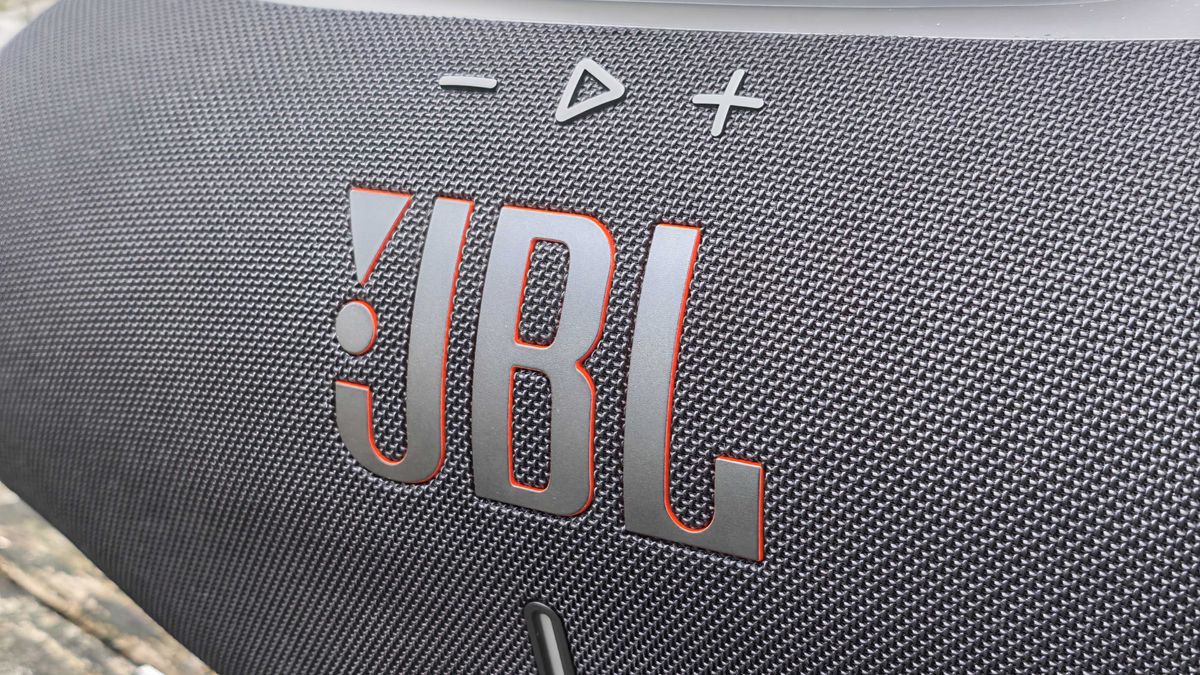 The JBL Boombox 4 on a table outside.
