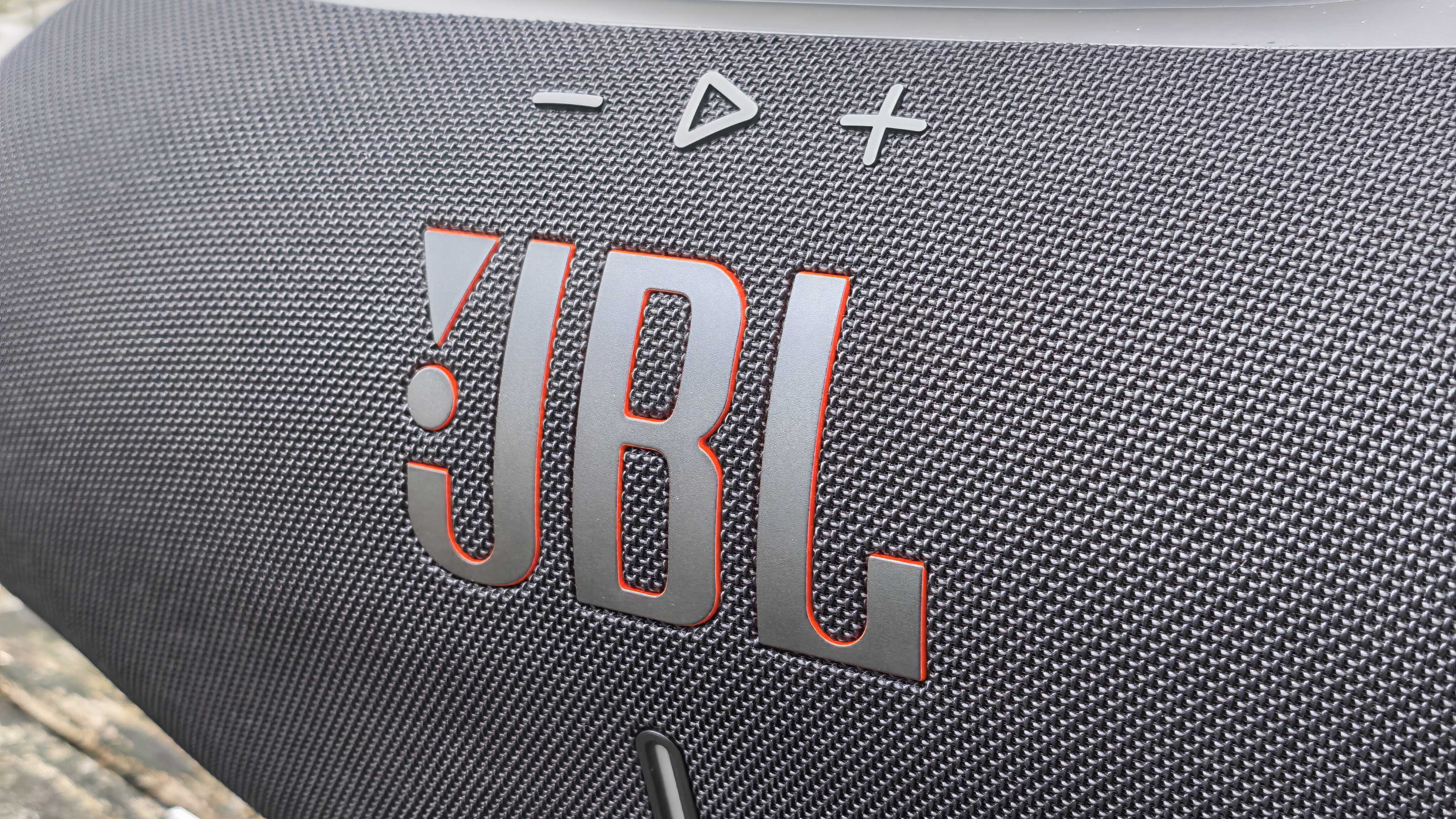 The JBL Boombox 4 on a table outside.