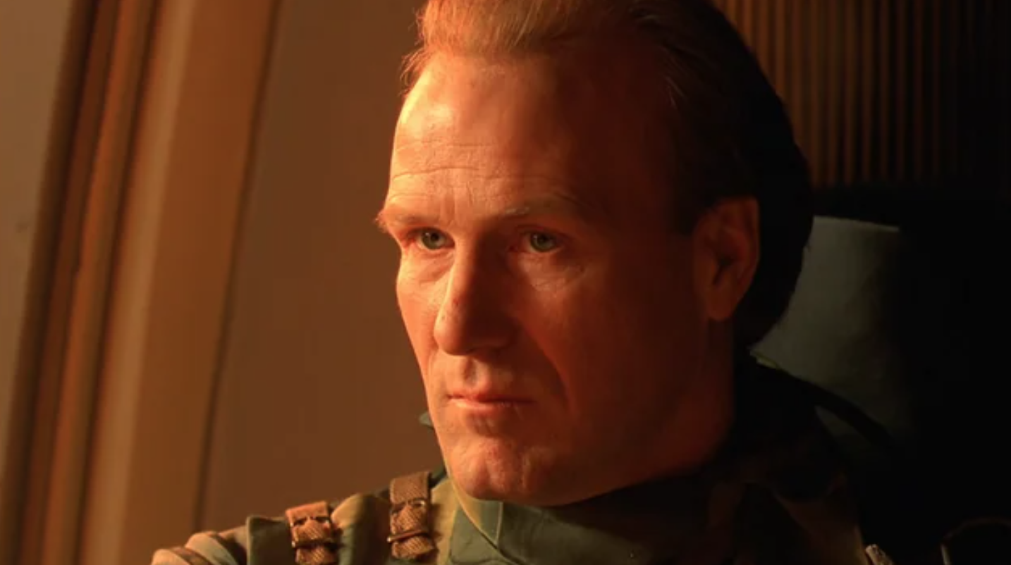 a blond-haired sci-fi character stares sternly