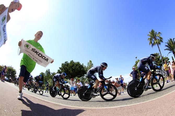 Team Sky zooms by some young fans