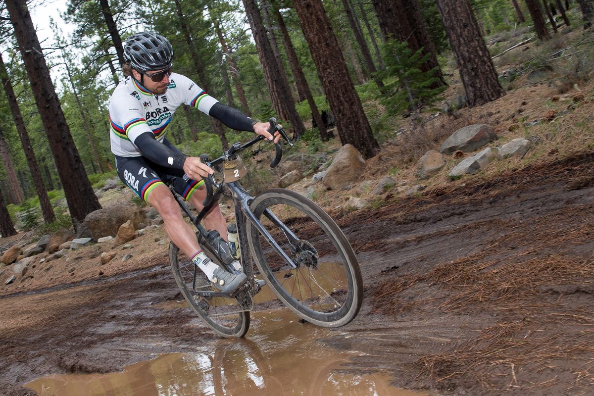 Peter Sagan wheelies over a mud puddle during the Sagan Fondo