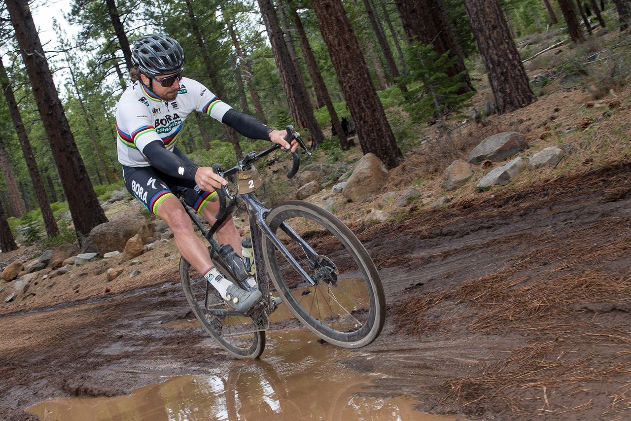 Peter Sagan wheelies over a mud puddle during the Sagan Fondo
