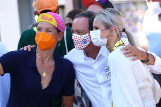 Kate Veronneau and Eric Min of Zwift pose with Marion Rousse at the Tour de France Femmes avec Zwift
