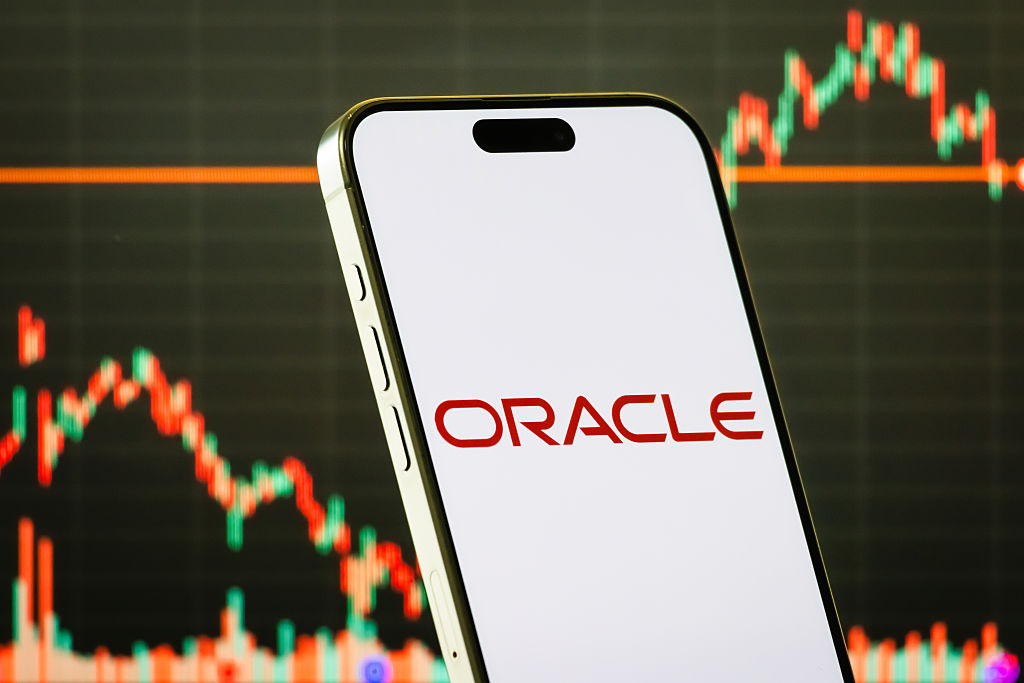 smartphone shows the logo of Oracle Corporation (NYSE: ORCL), a U.S. multinational computer technology company specializing in database software, cloud solutions, and enterprise applications, with the company's latest stock market chart seen in the background on September 4, 2025