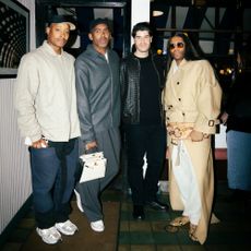 a photo of four guests at a dinner party