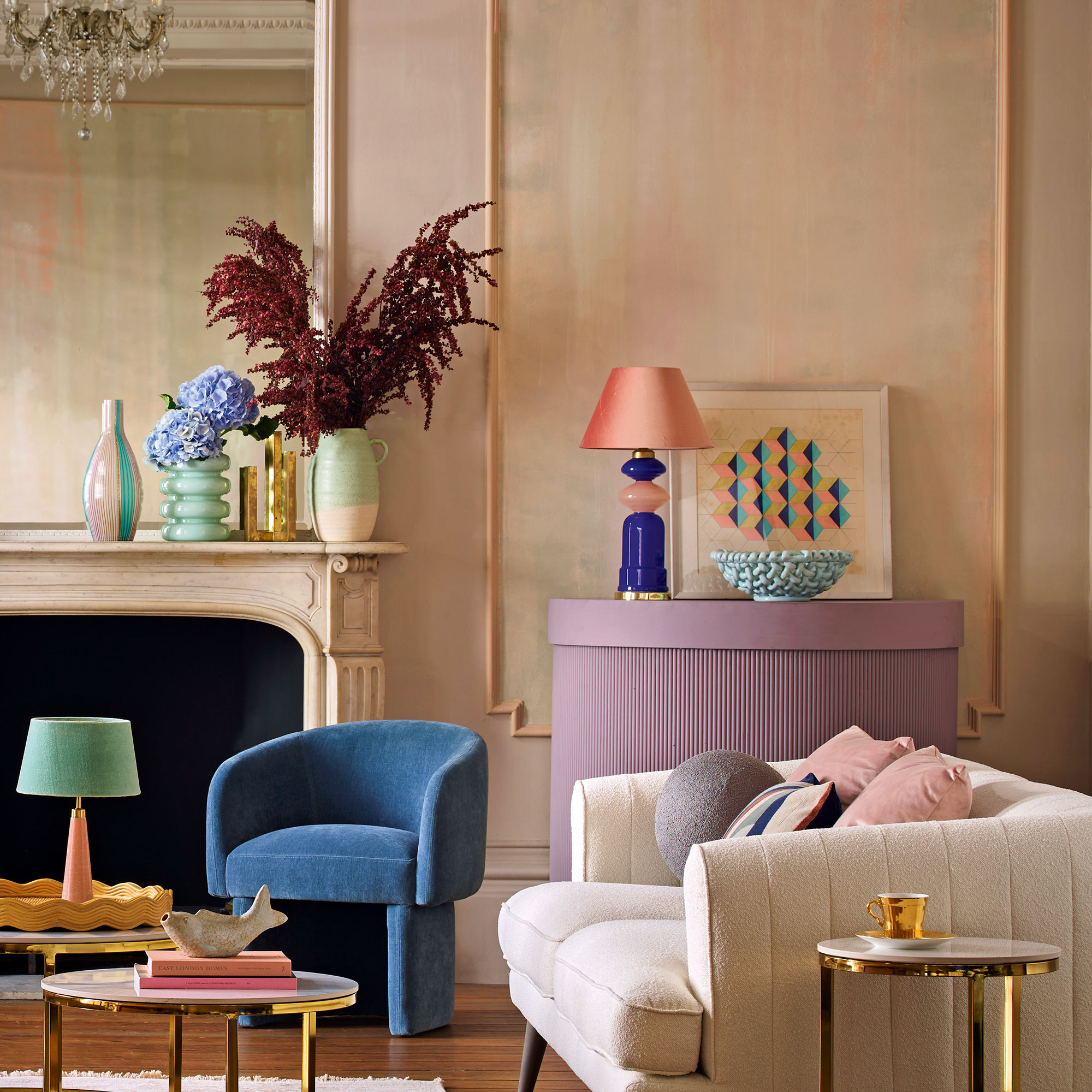 Plaster pink living room with white sofa and blue accent chair
