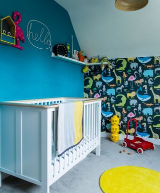nursery room with white cradle and animal wallpaper