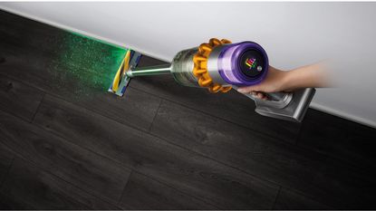 The Dyson v15 Detect vacuuming a hardwood floor