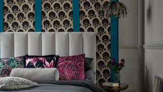 gothic-inspired bedtoom decor with velvet headboard patterned wall coverings and ornate light fitting