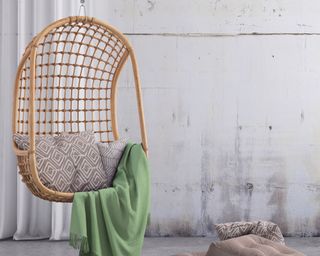 boho hanging chair with green blanket