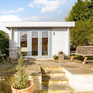 outdoor room with wooden shed and potted plants