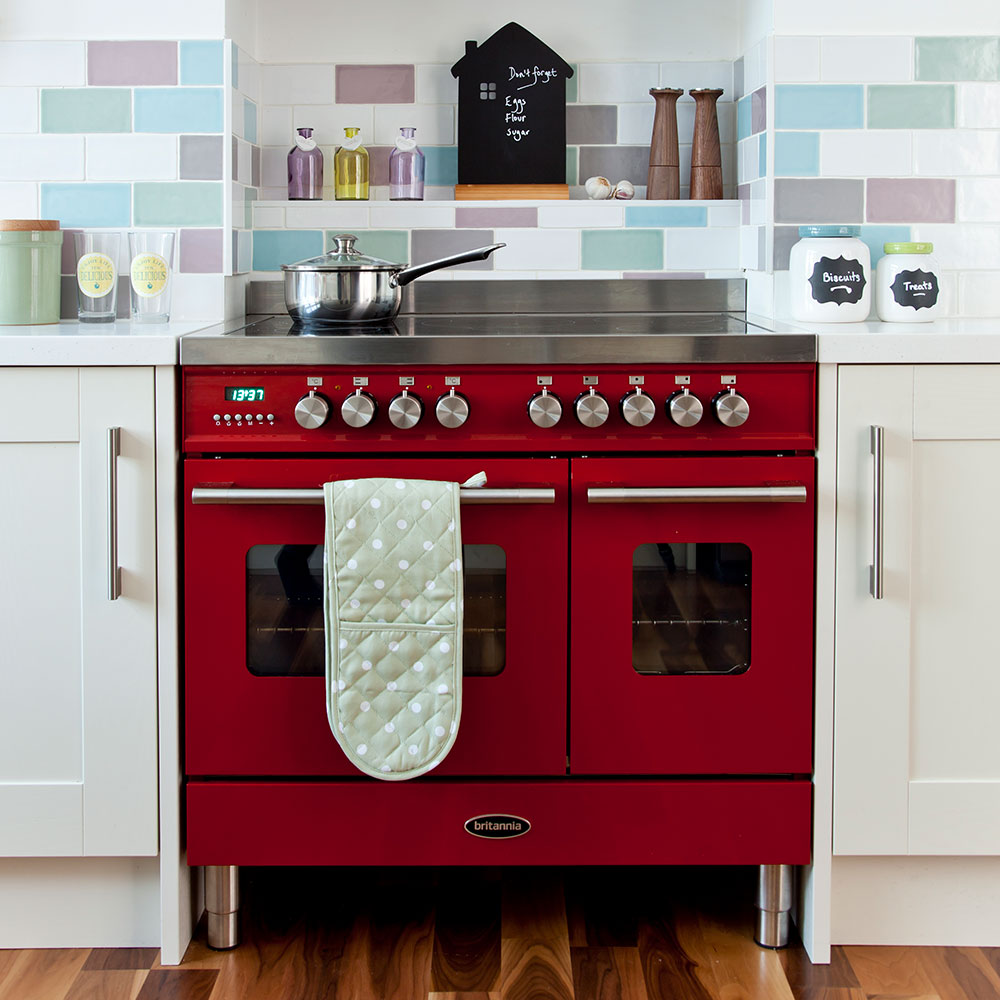 kitchen with mosaic wall tiles wooden flooring and microwave with white cabinet
