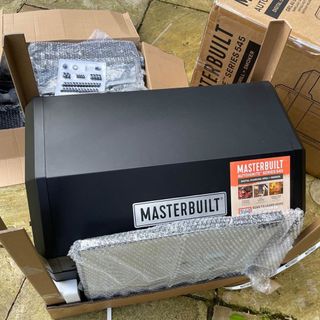 The Masterbuilt AutoIgnite 545 bbq unboxed on a patio