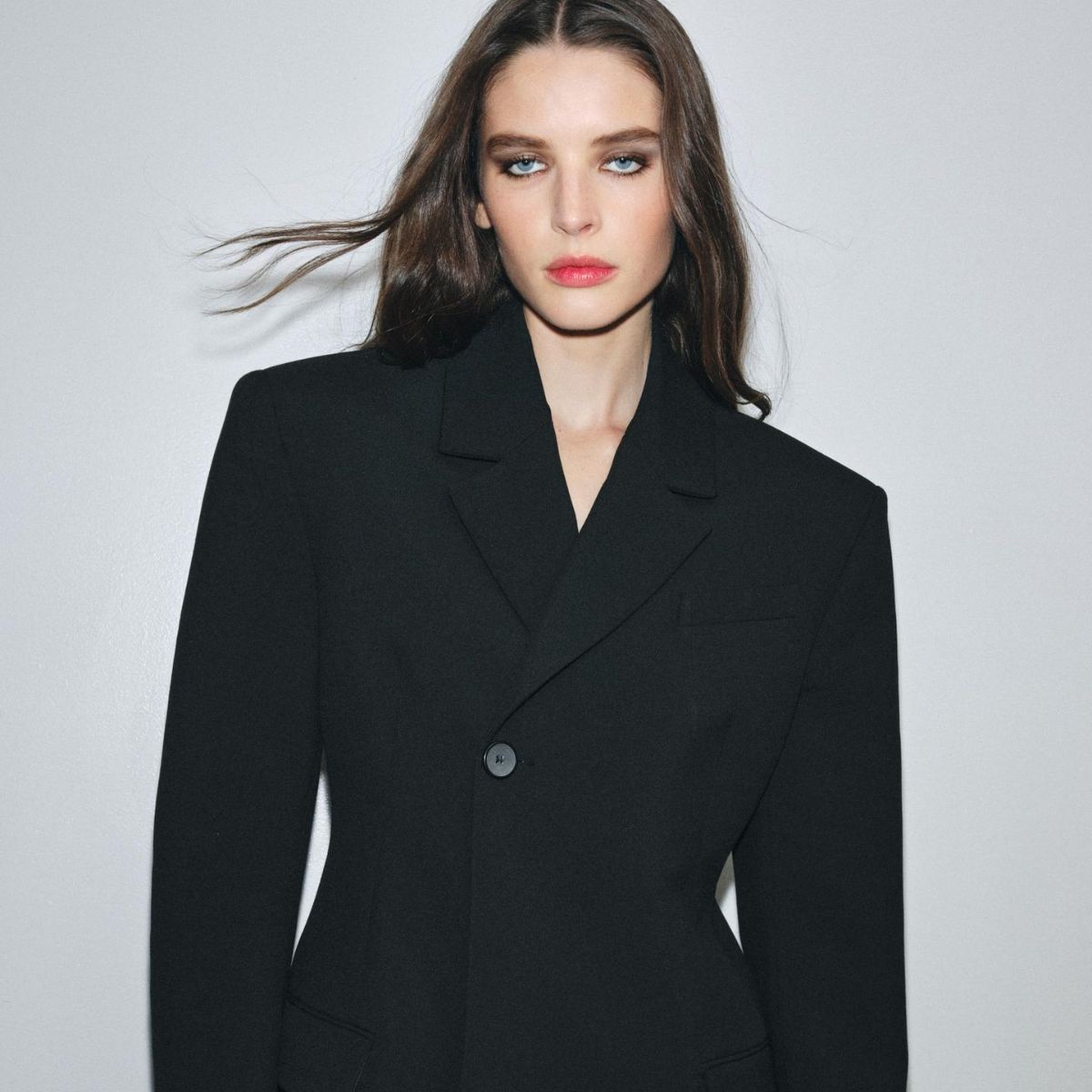 Woman wears fitted black blazer 