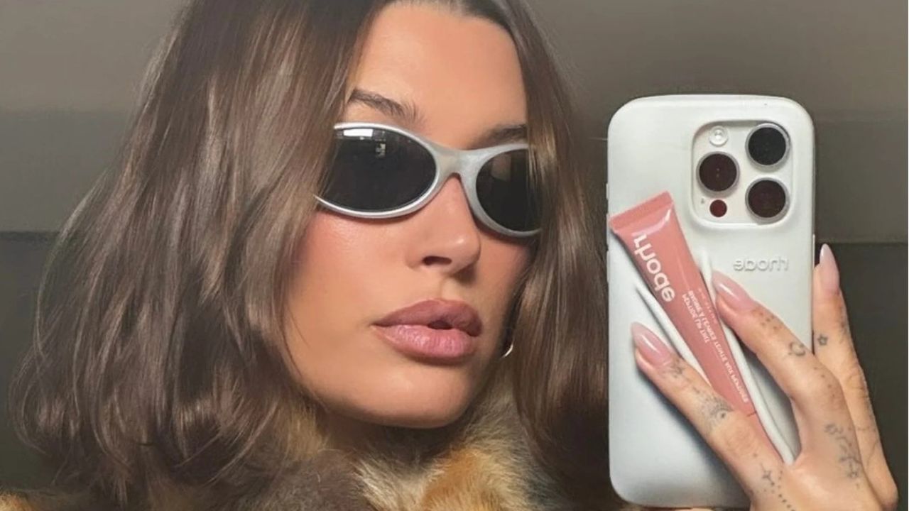 Hailey Bieber with Rhode lip gloss phone case