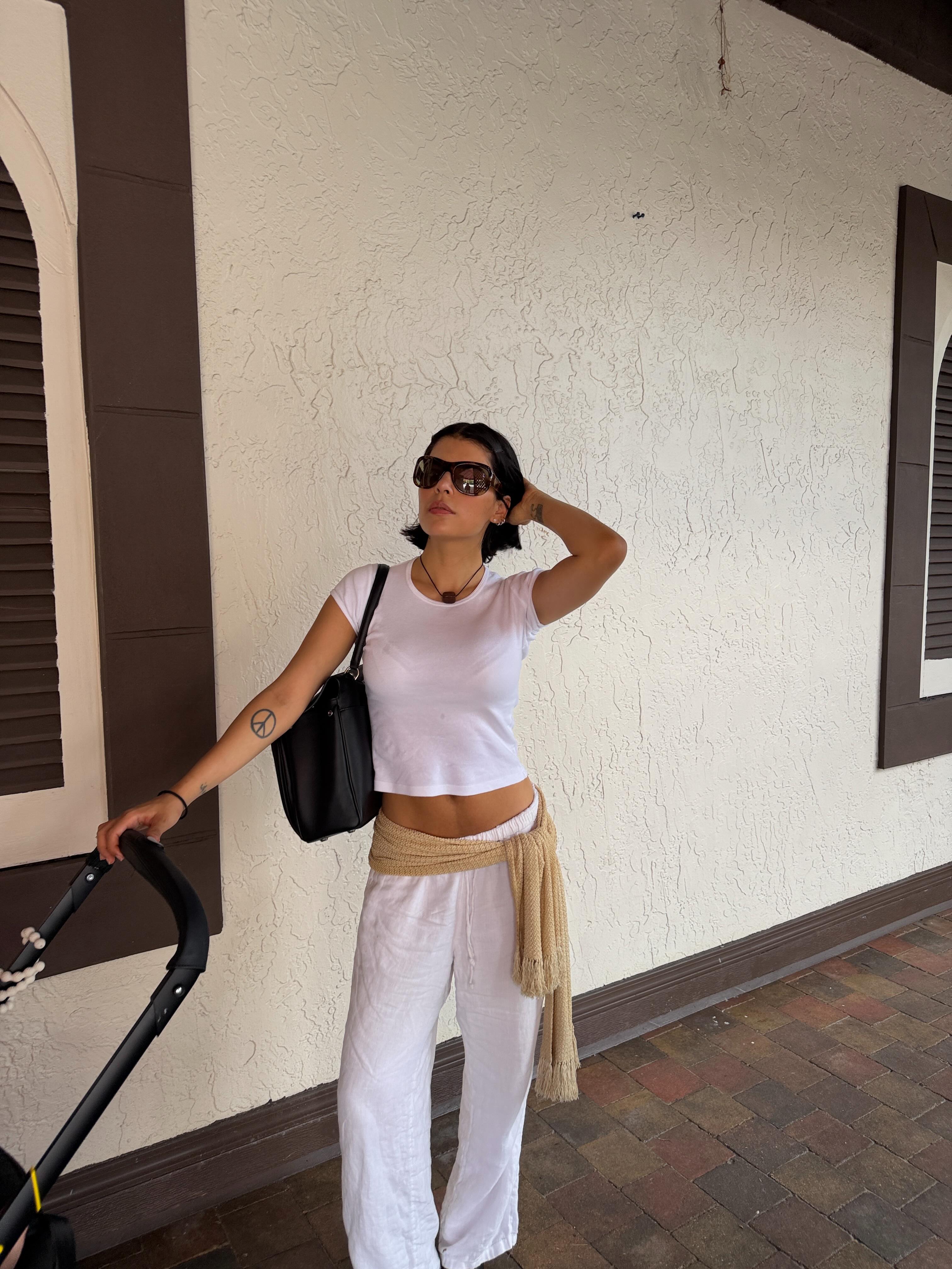 A woman wearing best white linen fashion item for summer 2026.