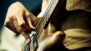 Close up of bass being played with fingers