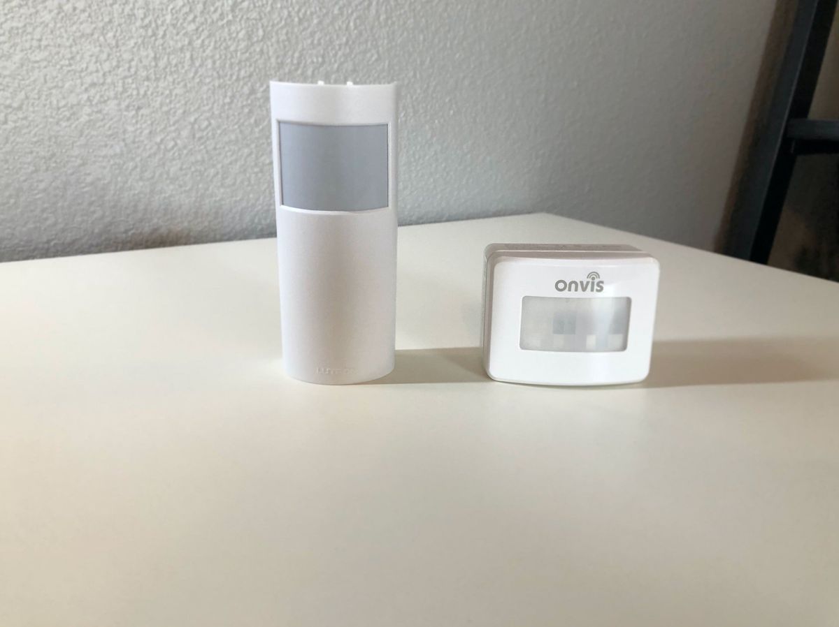 Lutron Caseta Wireless Motion Sensor next to Onvis SMS 1 Motion Sensor