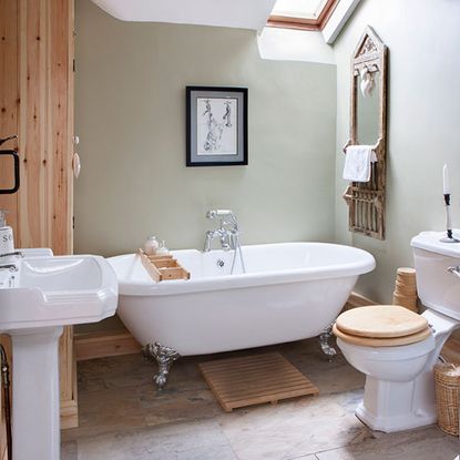 bathroom with frame on wall and bathtub