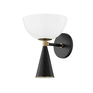 A wall light with brass detailing and frosted glass shade