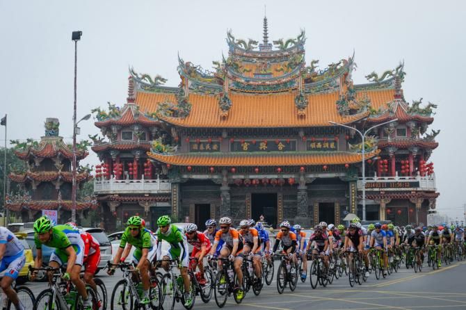 The riders in front of a big temple