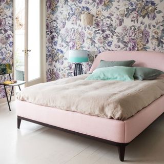 bedroom with floral wallpaper and pink bed