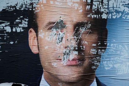 A defaced campaign poster for Emmanuel Macron