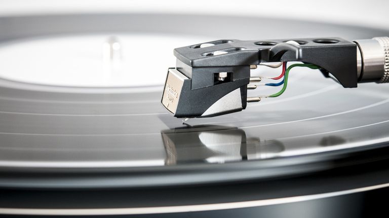 Best record player 2022, image shows a close-up of a turntable arm playing from a record