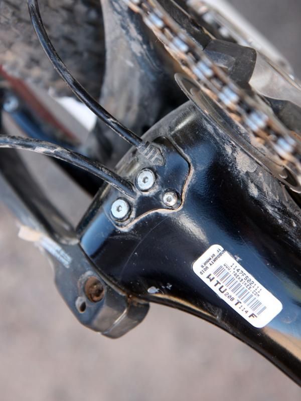The removable plate on the underside of the bottom bracket makes it easier to fish the lines through the exit ports. An additional clamp secures the rear brake hose to keep it from migrating inside the down tube.