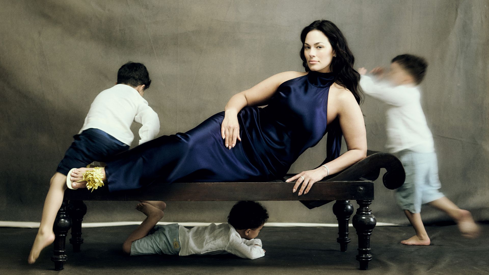 Ashley Graham poses for Marie Claire's latest cover story, as her kids play in the background