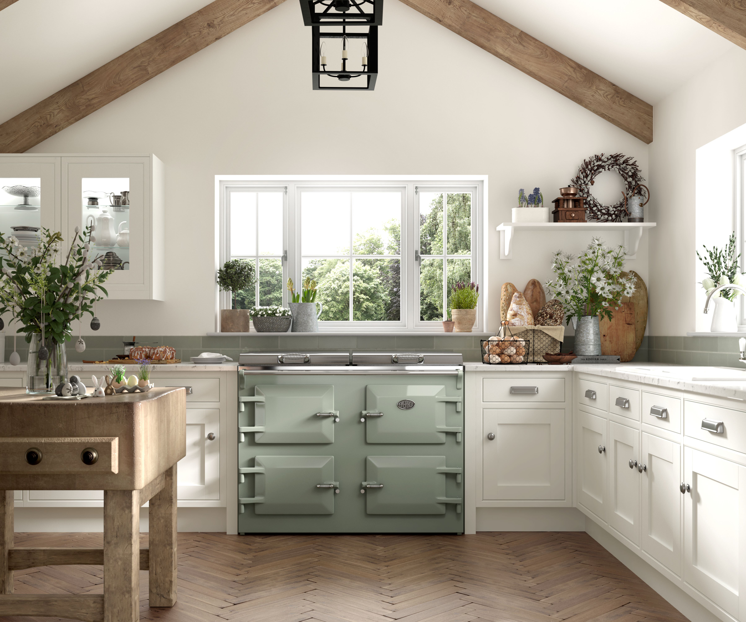 sage green range cooker in kitchen with white cabinets