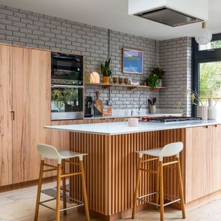 Wooden kitchen with metro tiles and open shelving