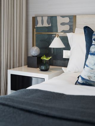 Headboard in a bedroom with bed and lighting