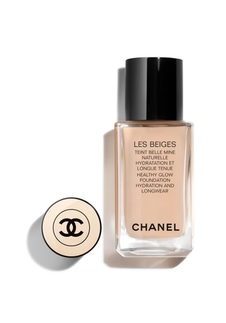 a bottle of chanel foundation in front of a plain backdrop