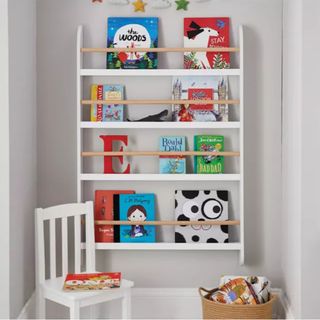 white bookcase on wall with books enclosed