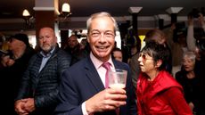 Nigel Farage holding a pint