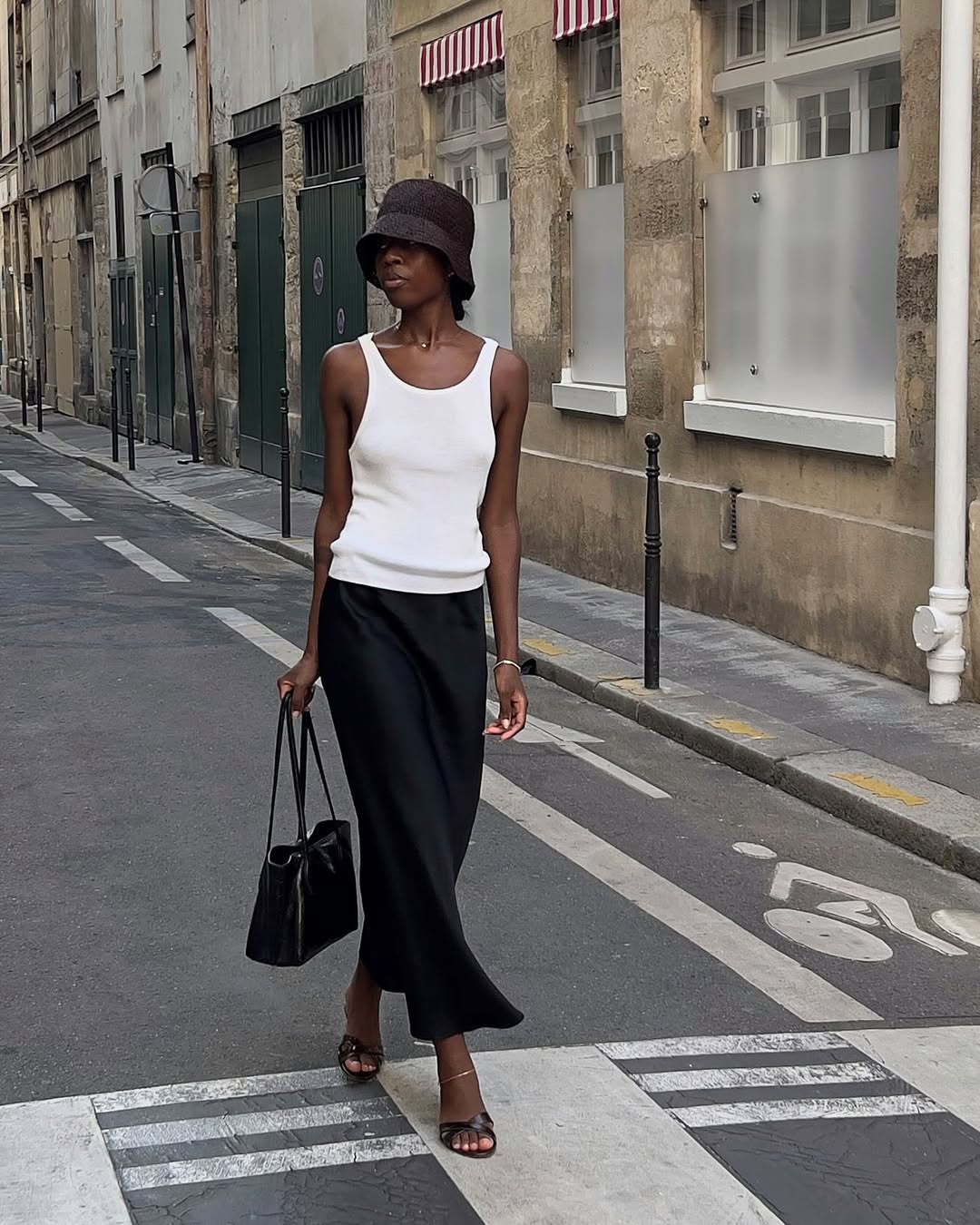 Sylvie in slip skirt, vest and sandals