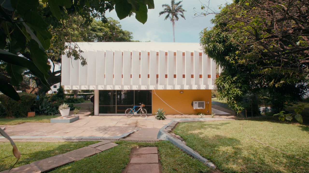 A white and orange house in the European modernist style