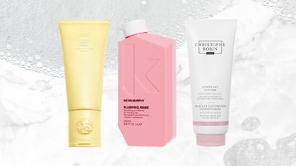 Lineup of three of the best conditioners for fine hair (L-R) from Oribe, Kevin Murphy and Christophe Robin, on a white marble background with foam pictures