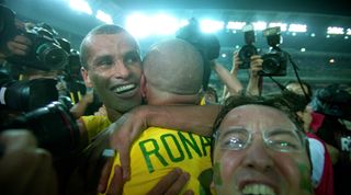30 June 2002 Yokohama : FIFA World Cup Final - Brazil v Germany : a fan invades the post match Brazil celebration between Rivaldo and Ronaldo (photo by Mark Leech/ Getty Images)
