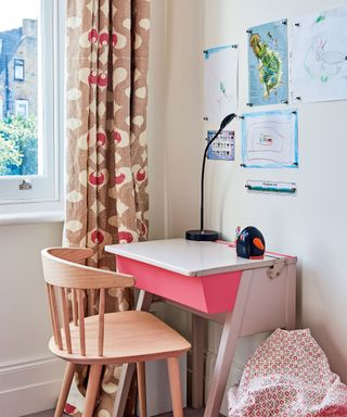 Red accent color used on a desk and curtains in kids' bedroom ideas.