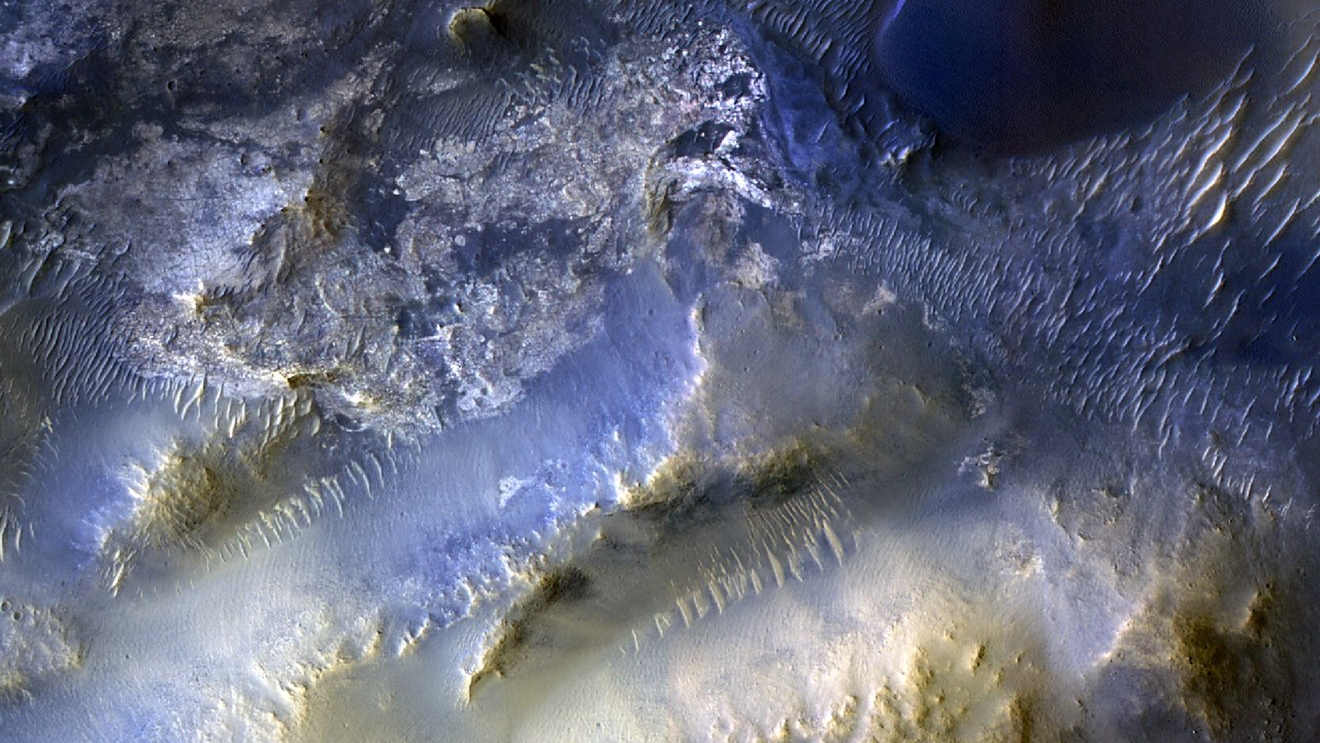 This view of a region called Syrtis Major is from the 100,000th image captured by NASA&rsquo;s Mars Reconnaissance Orbiter using its HiRISE camera. The image was snapped on Oct. 7, 2025. Over nearly 20 years, HiRISE has helped scientists understand how the Red Planet&rsquo;s surface is constantly changing.
