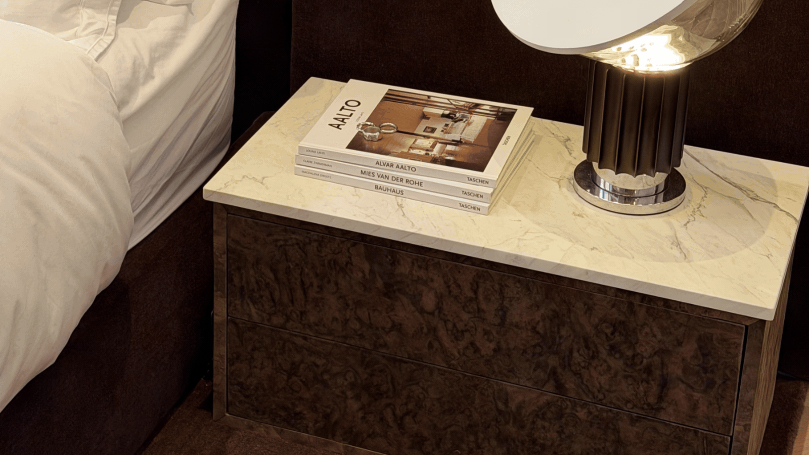 GIF of three rotating images that show an ikea hack of a nightstand that has burl wood sides and a white marble top.